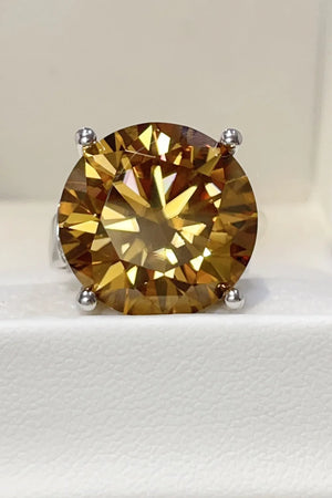 Gold cocktail ring with a large radiant cut moissanite gemstone.
