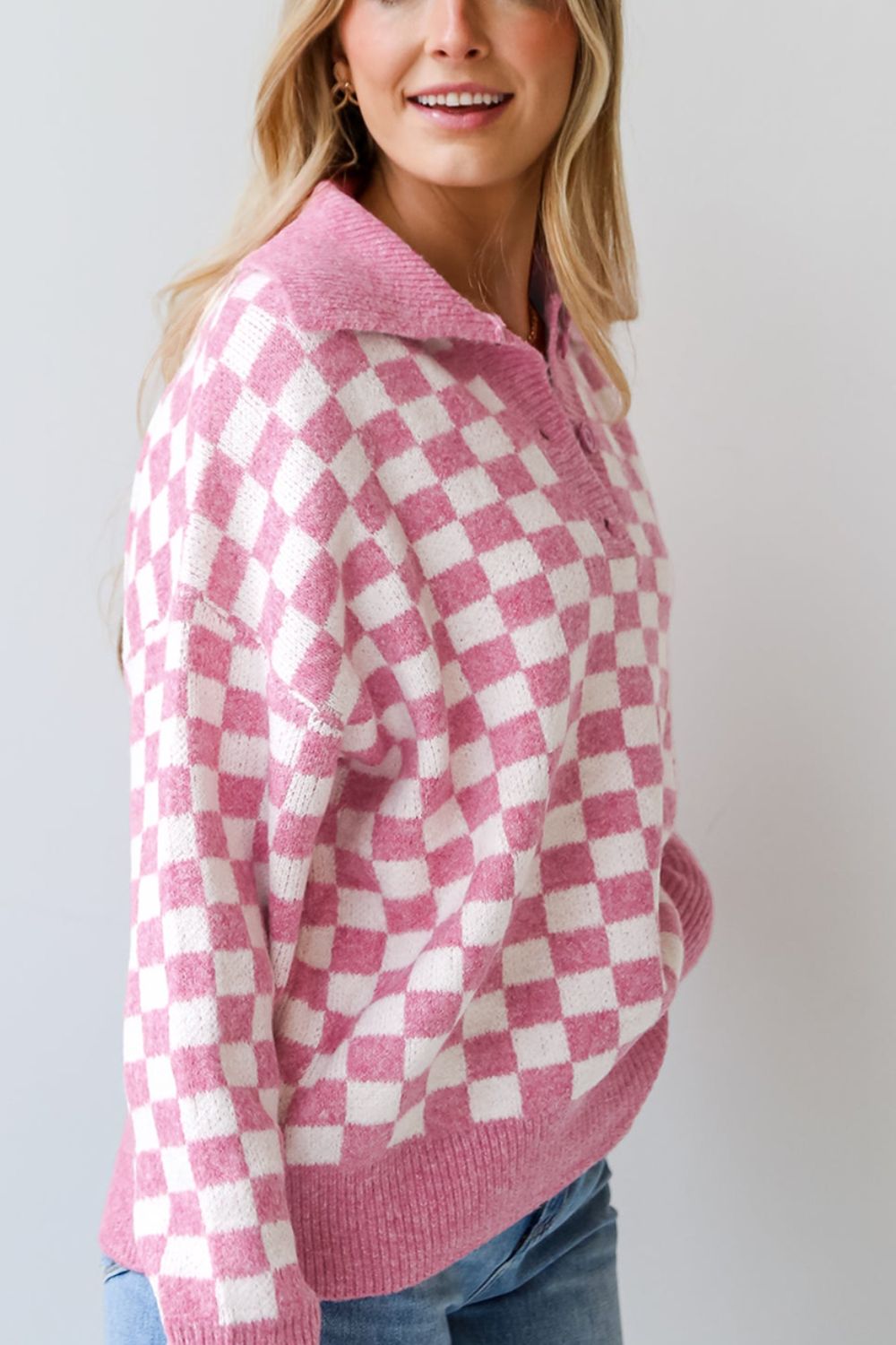 Pink checkerboard knit polo sweater with button detail and collar