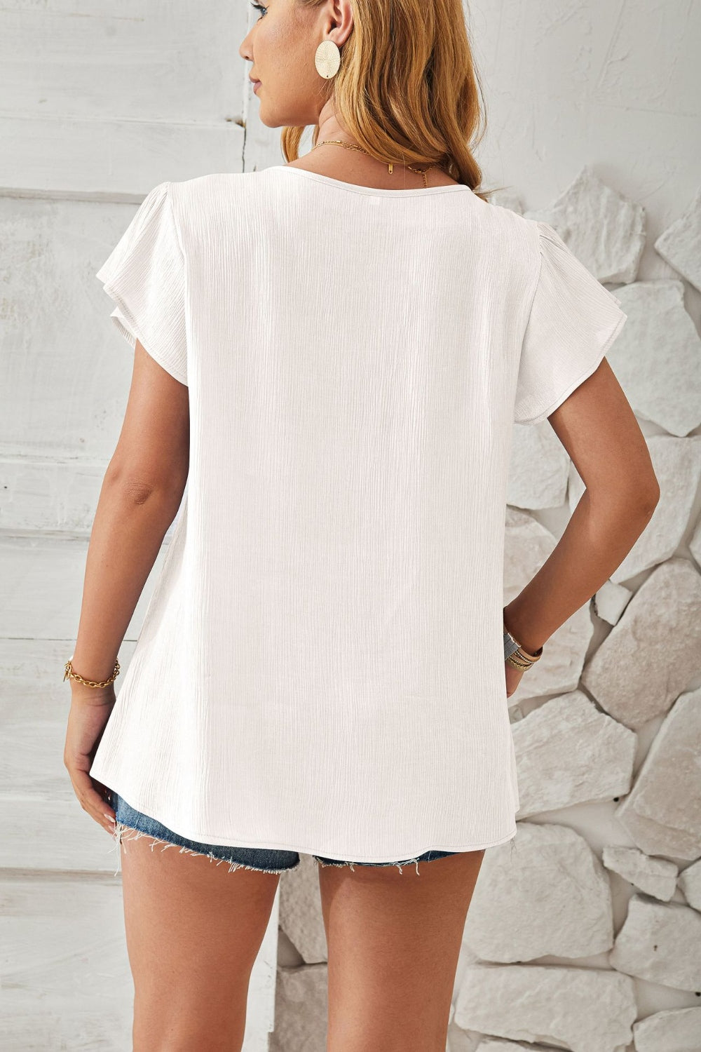 White textured V-neck blouse with pleated cap sleeves