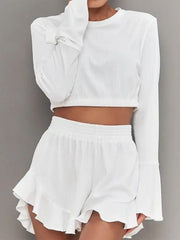 White ribbed crop set with flared sleeves and ruffled shorts