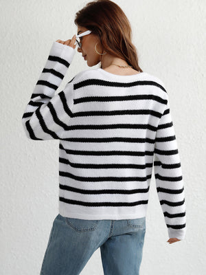 Black and white horizontal stripe knit sweater with crew neck and long sleeves.