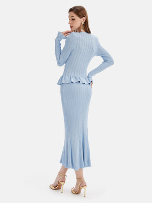 Light blue knit cardigan set with ruffled peplum and flared midi skirt.