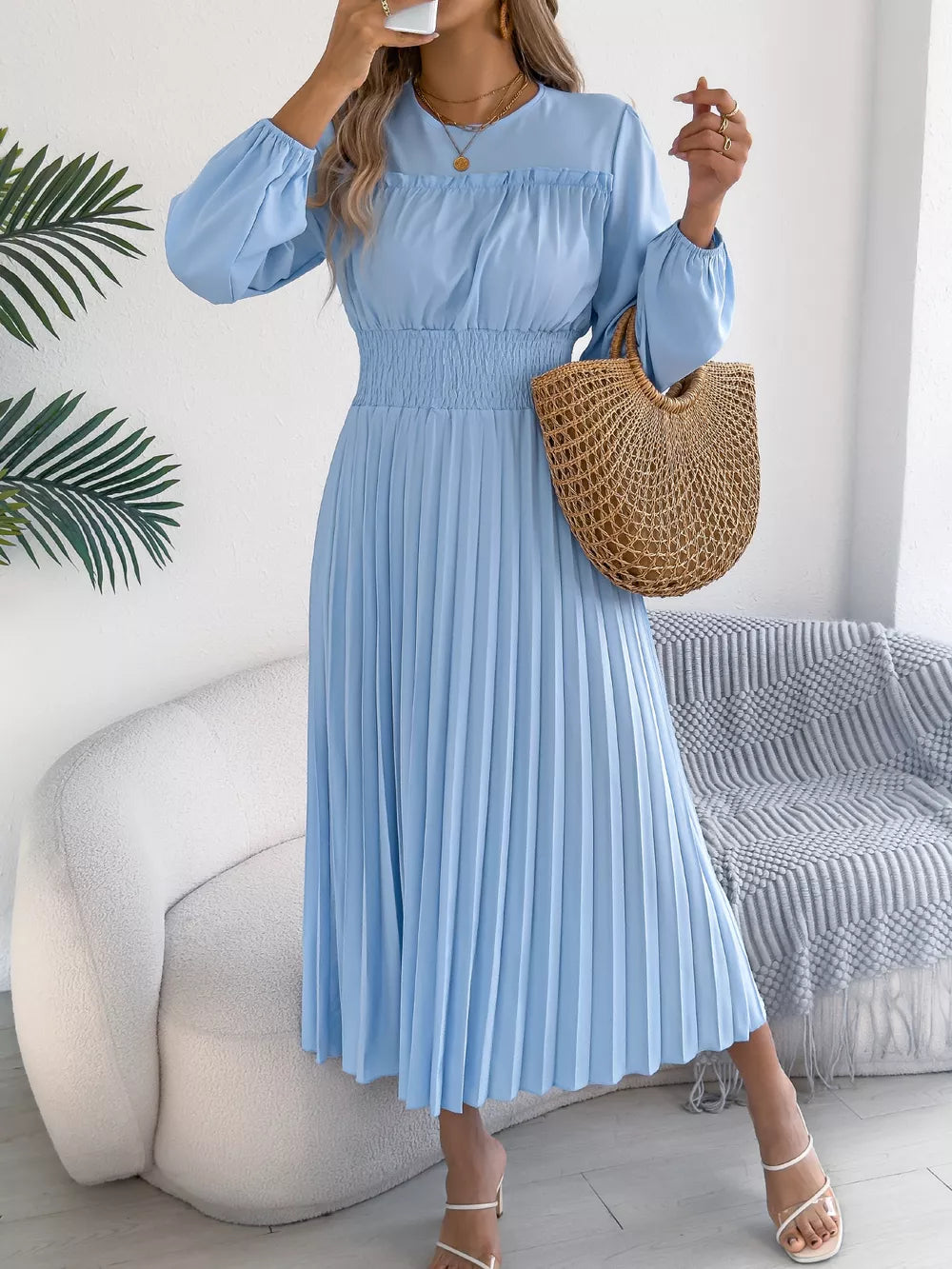 Light blue midi dress with ruffled neckline, smocked waist, and pleated skirt.