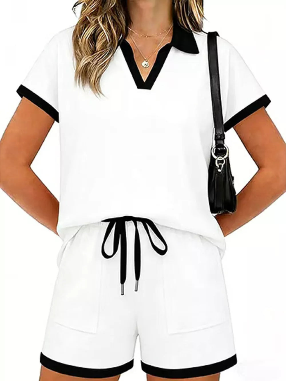 White polo collar two-piece set with black trim, drawstring shorts with pockets.