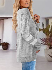 Light gray raglan v-neck top with white varsity stripes on sleeves