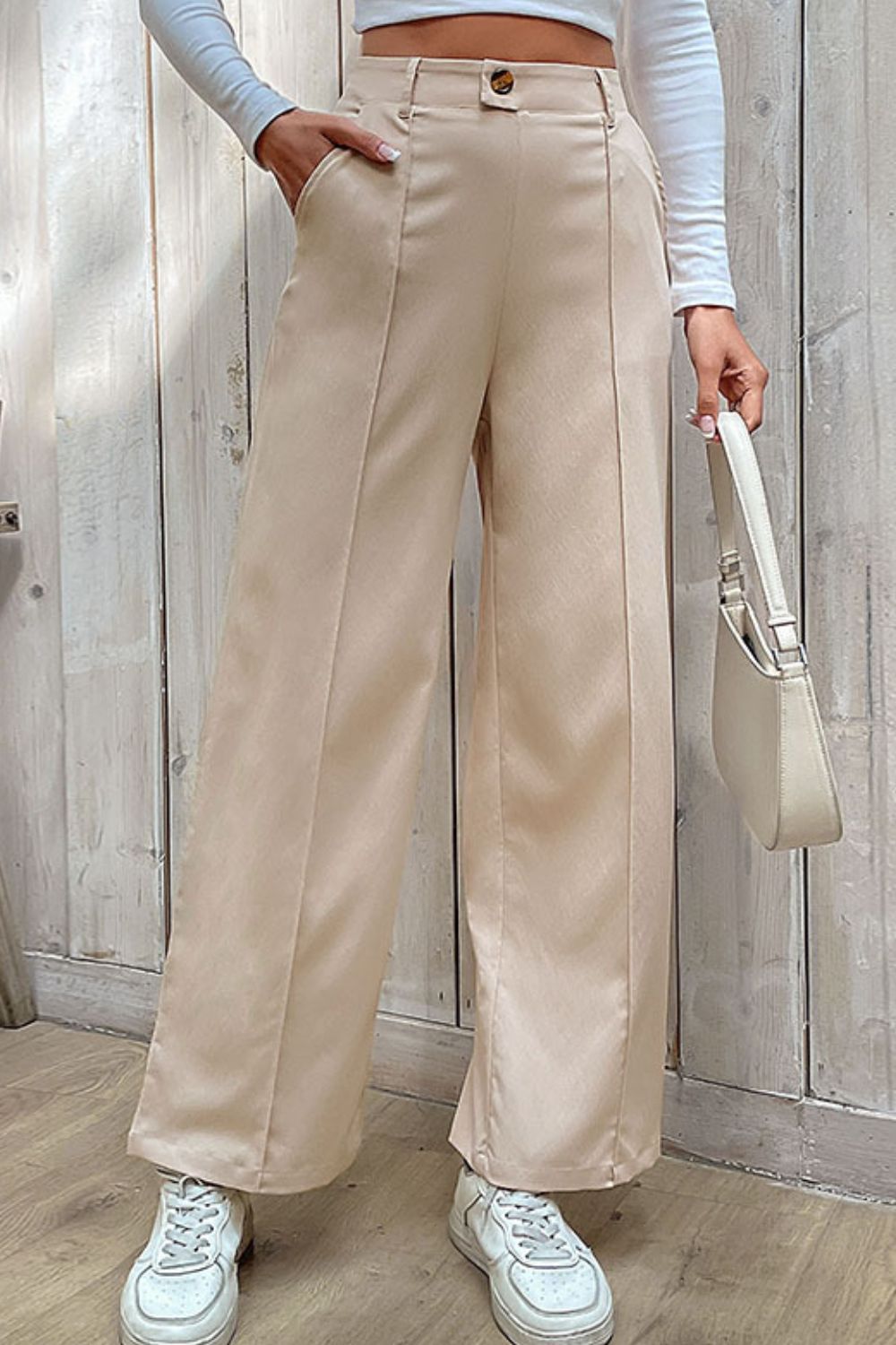 Beige tailored seam wide-leg trousers with a high waist and button closure.