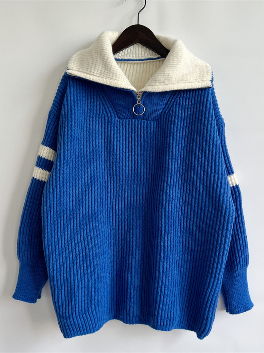 Royal blue acrylic sweater with white varsity stripes on sleeves and ribbed collar with half zip.