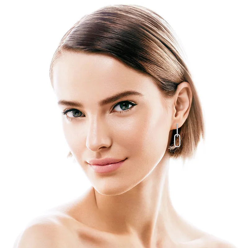 Geometric moissanite drop earrings in gold with a modern rectangular design.
