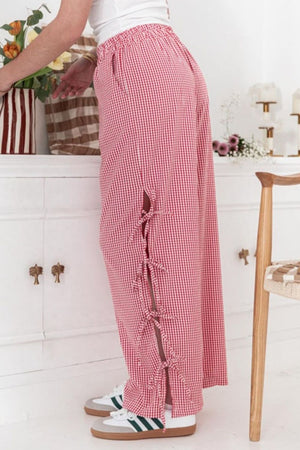 Gingham palazzo trousers in scarlet with side tie details and elastic waist.