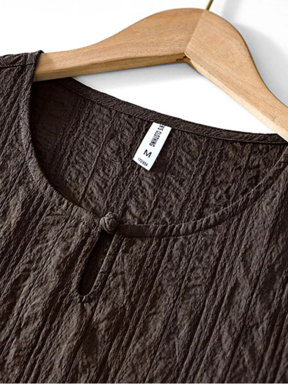 Textured chocolate short sleeve men's blouse with round neckline and knot detail.