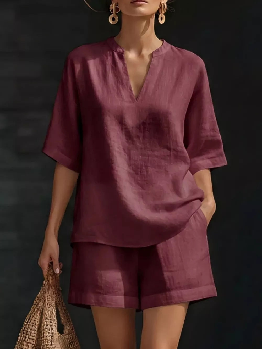 Effortless oversized two-piece set in fuchsia pink with V-neck top and shorts.