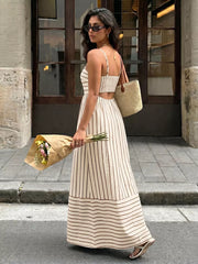 Patterned cutout maxi dress with smocked detail in apricot and brown stripes.