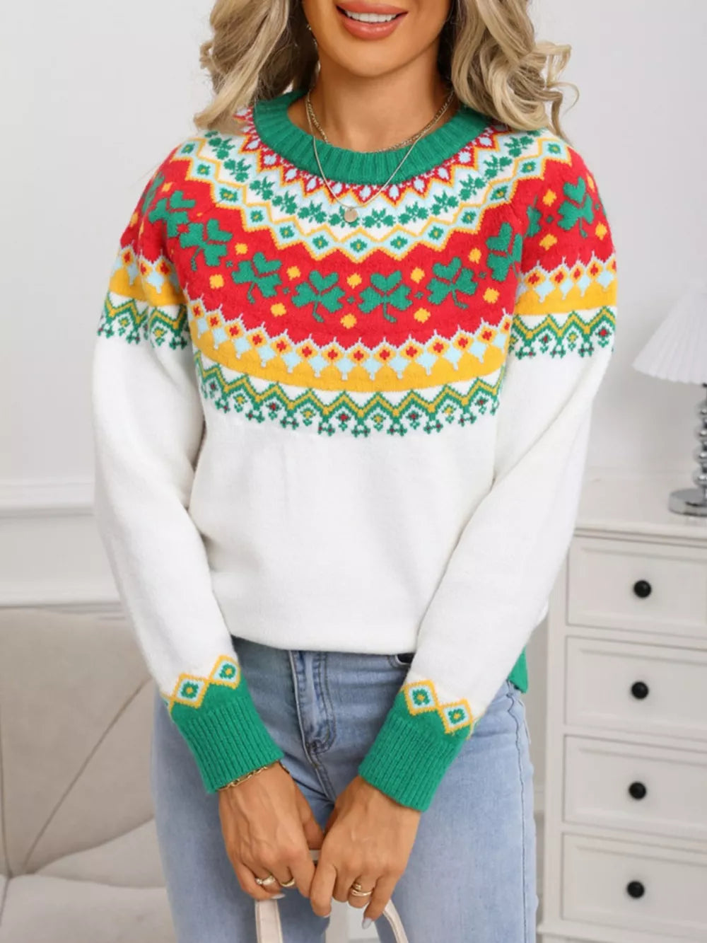 White knit sweater with charming clover and geometric pattern, green cuffs and neckline.