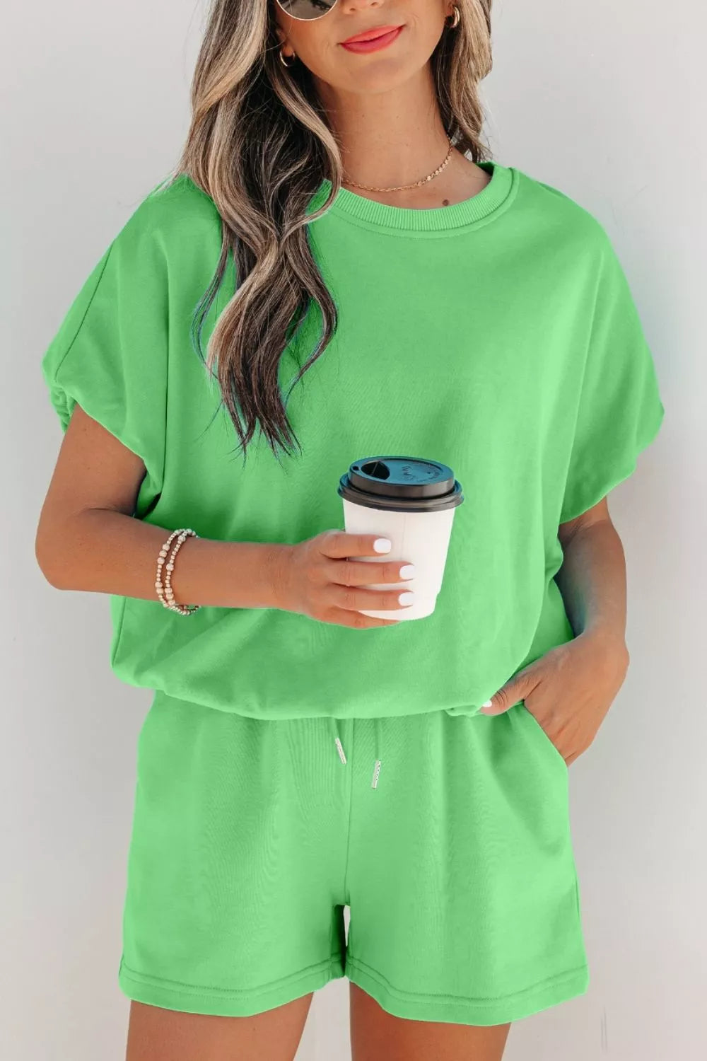 Green cotton drawstring shorts and crewneck t-shirt set with short sleeves.