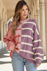 Colorblock stripe knit pullover sweater in pink and purple with cream stripes.