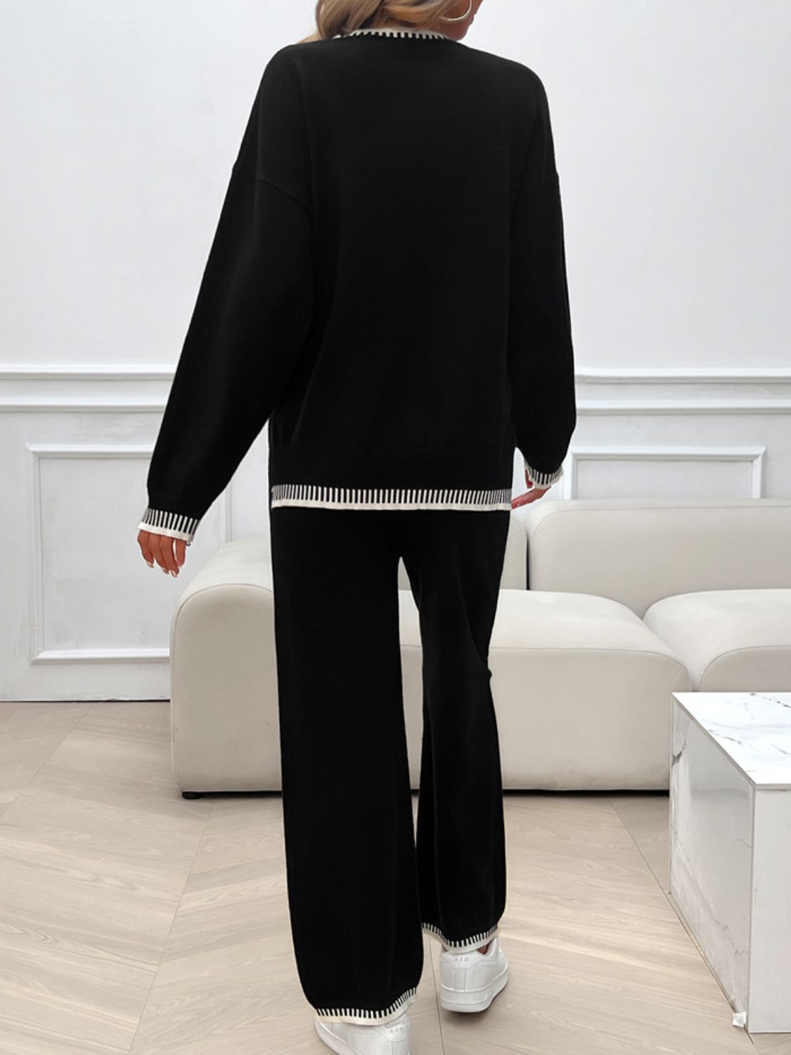 Black ribbed trim knit lounge set with wide leg pants and crewneck sweater.