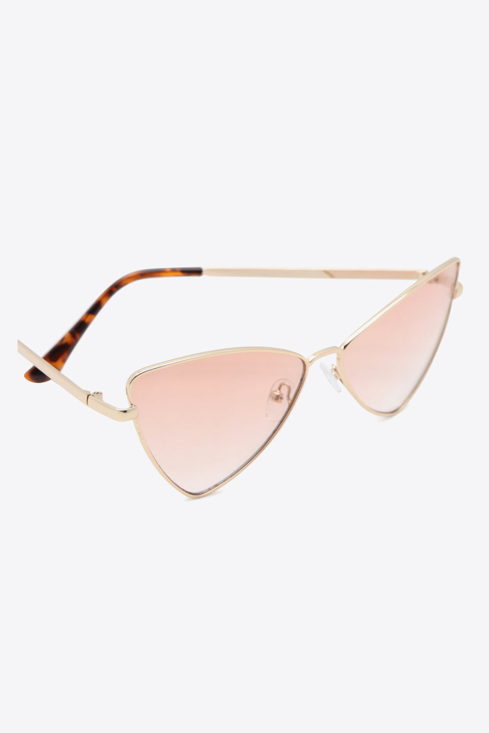 Angular cat-eye sunglasses with gradient lenses and gold frames.