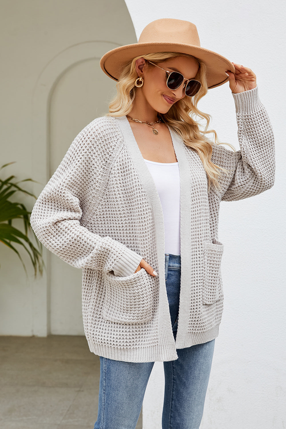 Light gray waffle knit raglan pocket cardigan with open front and long sleeves.