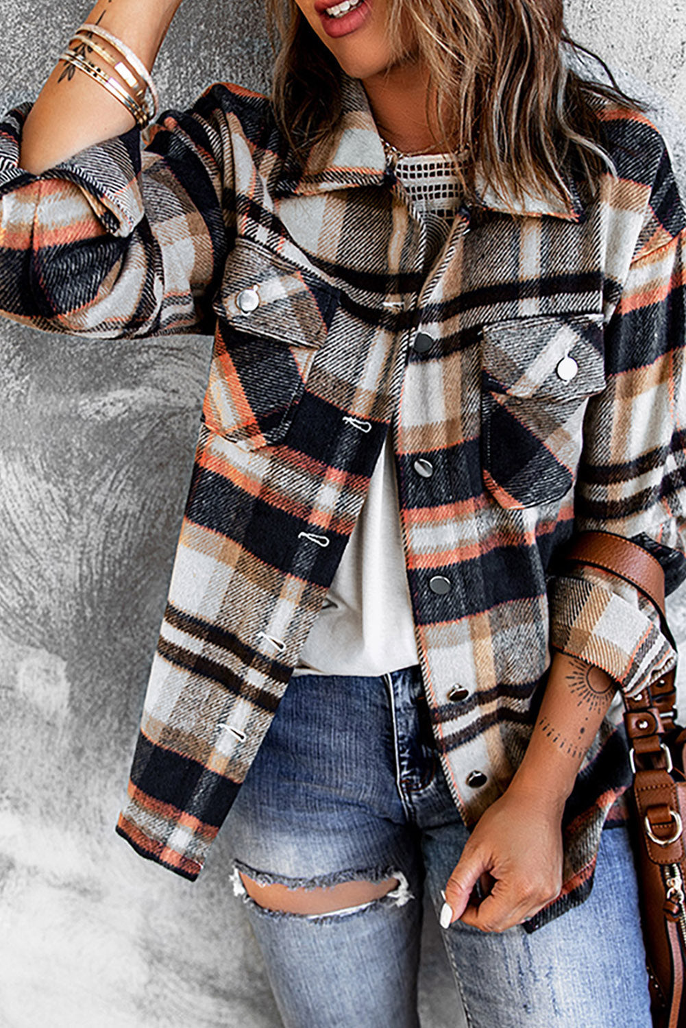 Soft plaid shacket with patch pockets and button details, featuring orange, black, and grey tones.