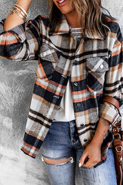Soft plaid shacket with patch pockets and button details, featuring orange, black, and grey tones.