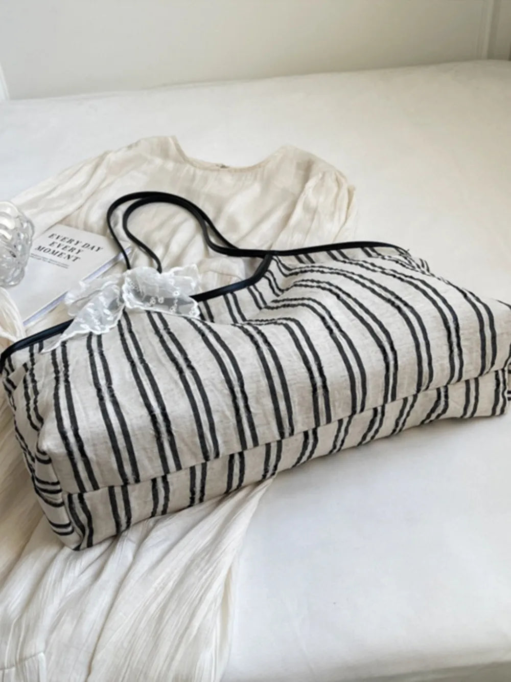Beige shopper bag with black stripes and lace bow detail