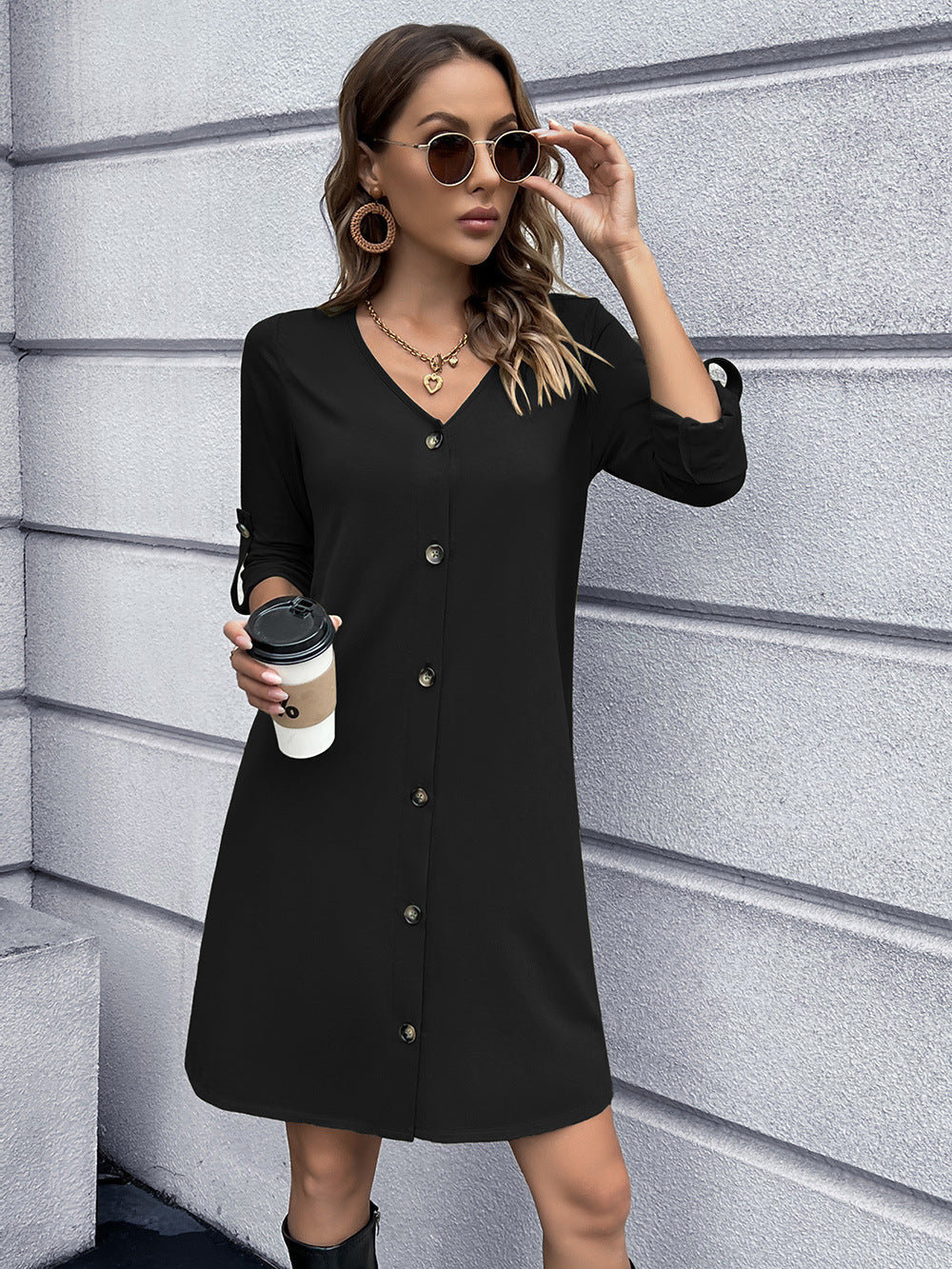 Black button-down mini dress with V-neck and cuffed sleeves.