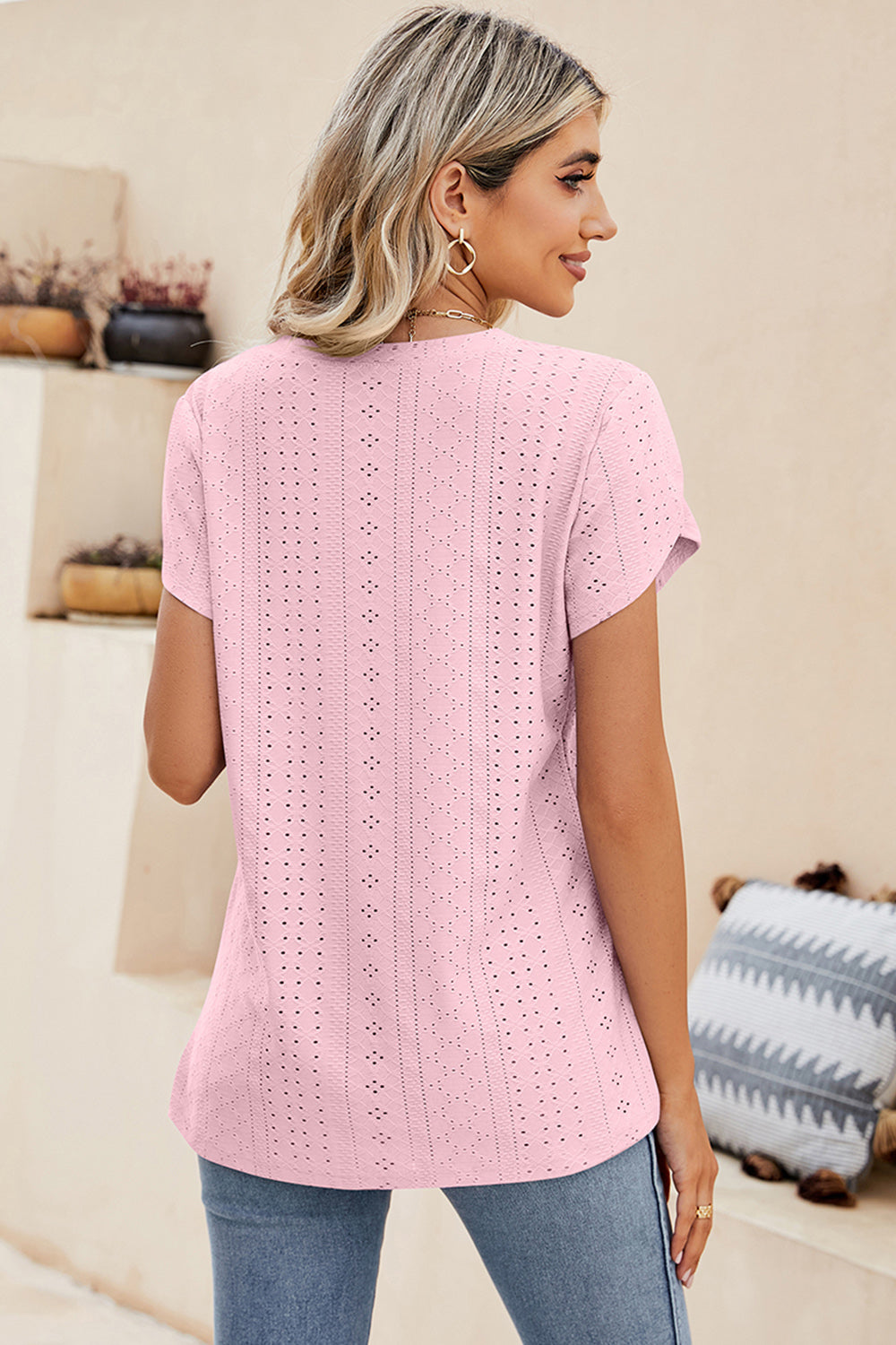 Blush pink eyelet v-neck top with short sleeves and a breathable casual fit.