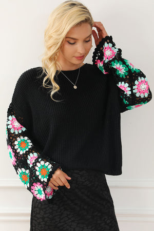 Black knit pullover sweater with colorful crochet granny square bell sleeves.