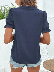 Navy blue textured puff sleeve blouse with ruffled cuffs and a collared neckline.