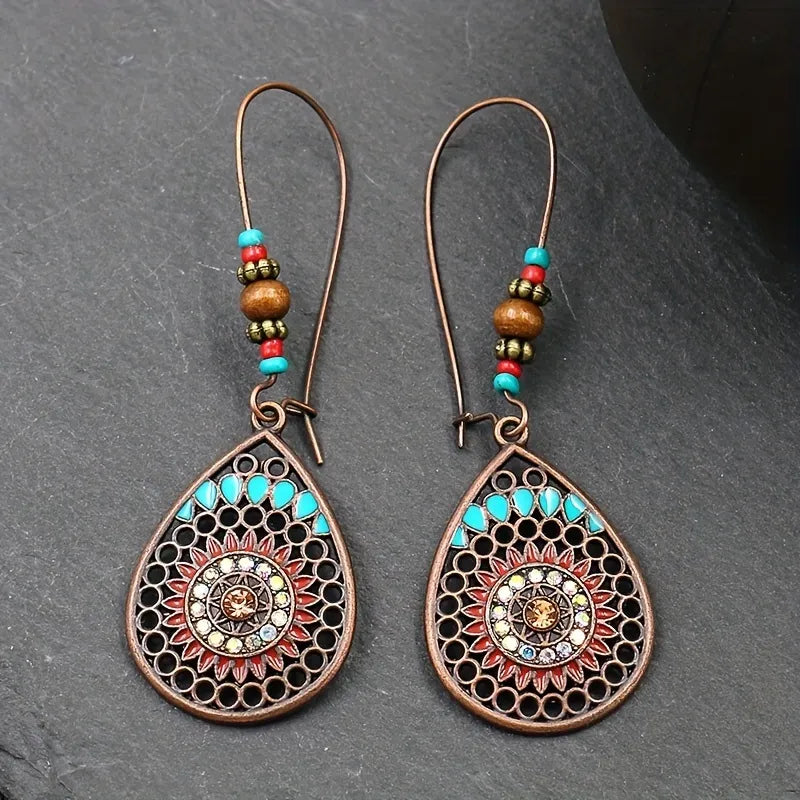 Bohemian mandala drop earrings in copper with turquoise and red accents, featuring beaded detail.