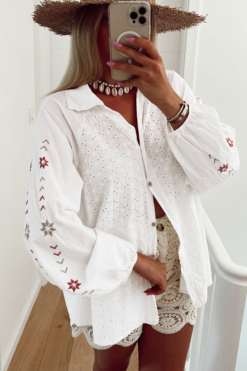 White embroidered eyelet blouse with poet sleeves and boho detailing.