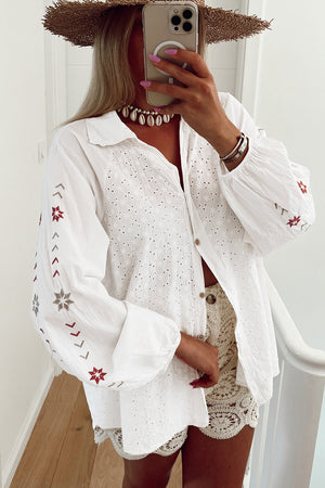White embroidered eyelet blouse with poet sleeves and boho detailing.