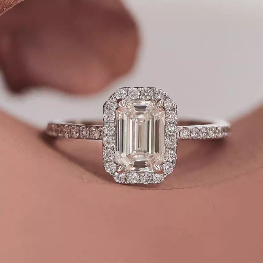 Radiant Moissanite engagement ring in silver with emerald-cut center stone and diamond halo.