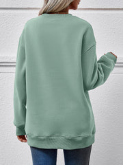 Sage green crewneck sweatshirt with ribbed cuffs and hem, relaxed fit.