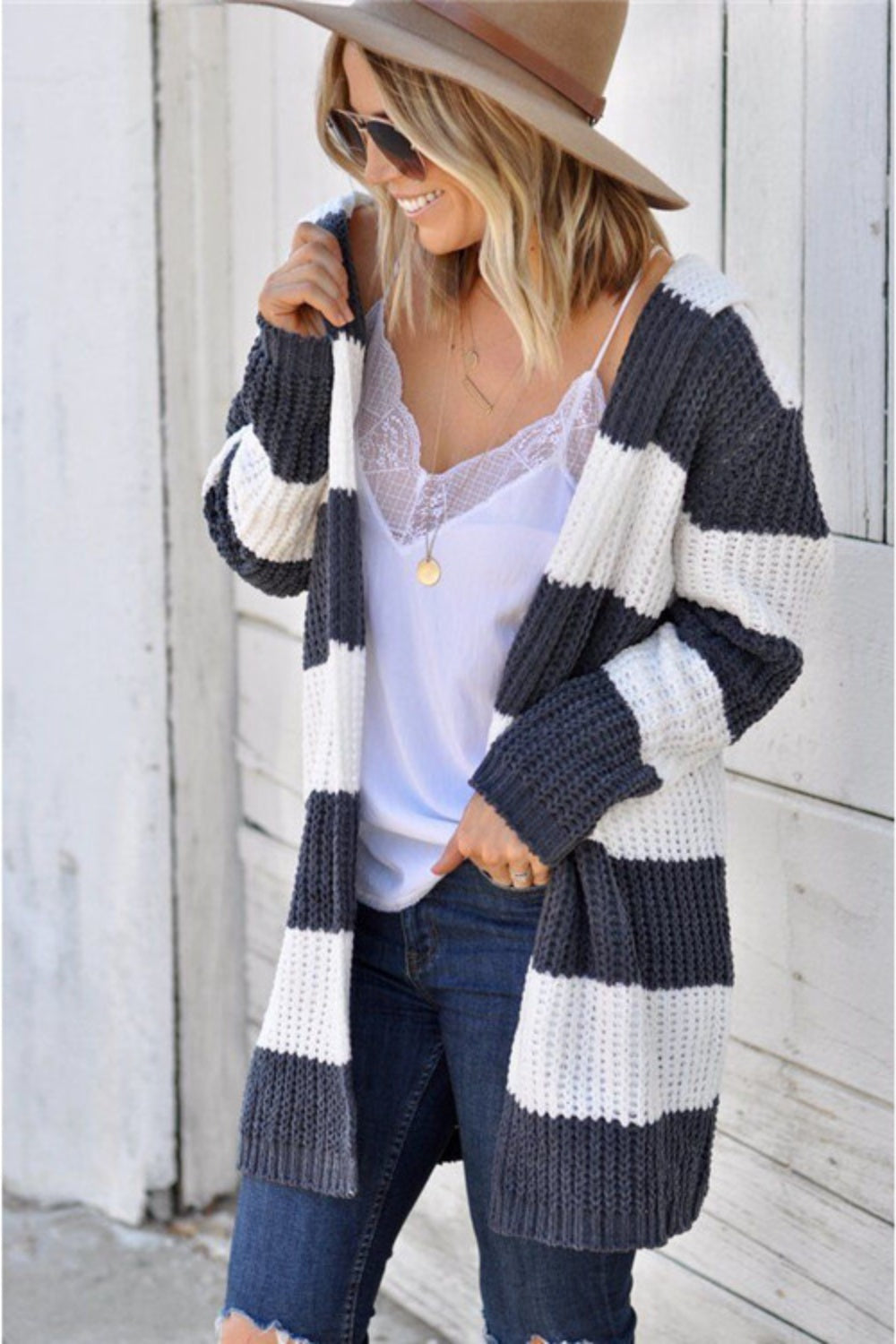 Chunky knit hooded cardigan with wide stripes in cream and charcoal grey, open front, long sleeves.