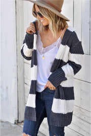 Chunky knit hooded cardigan with wide stripes in cream and charcoal grey, open front, long sleeves.