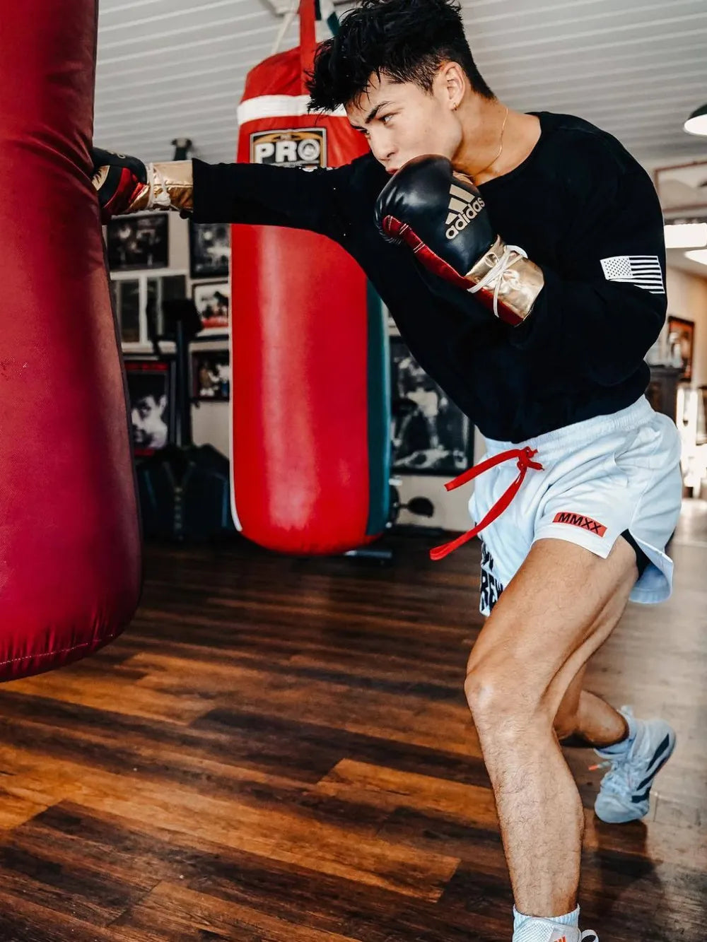 White graphic training shorts with red drawstring and MMX logo detail.