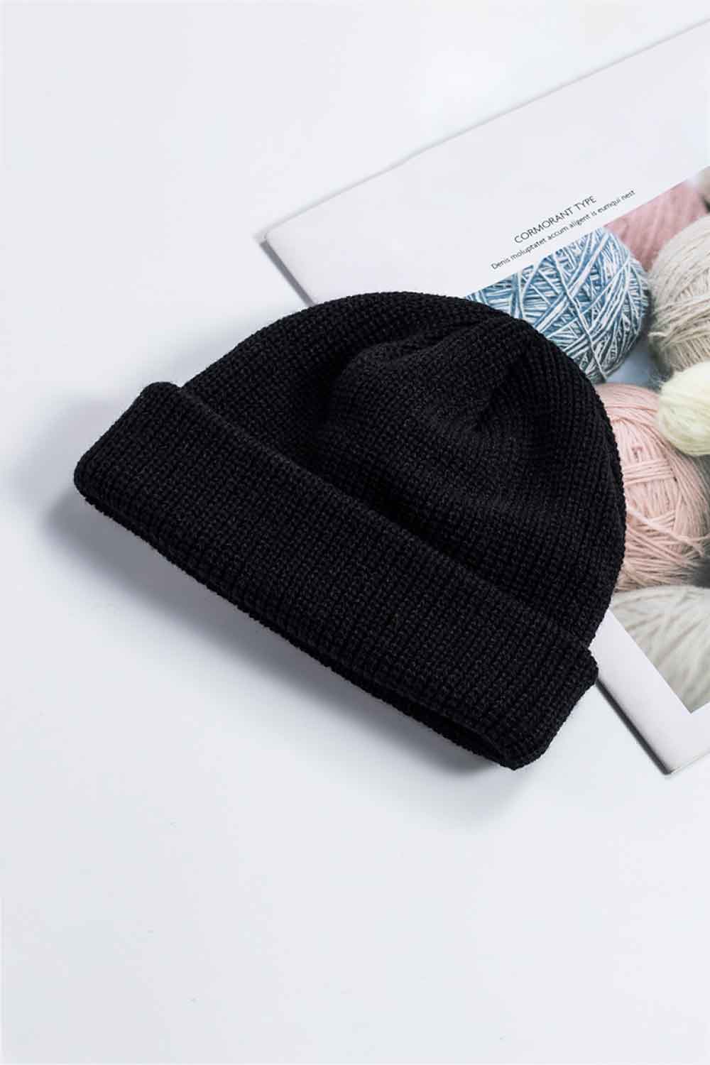 Black ribbed knit beanie with a turn-up cuff