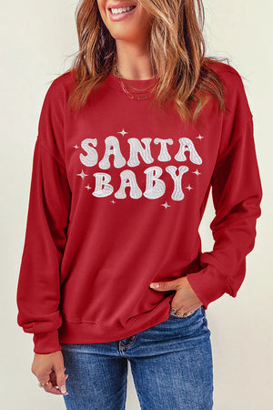 Red crewneck sweatshirt with white Santa Baby graphic and stars, casual long sleeve.