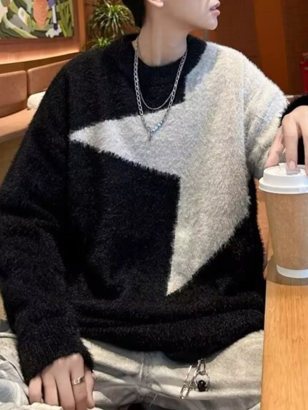 Men's black and grey fuzzy knit sweater with geometric pattern, crew neck.
