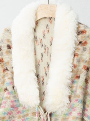 Textured plaid acrylic poncho with cream faux fur collar and colorful geometric pattern.