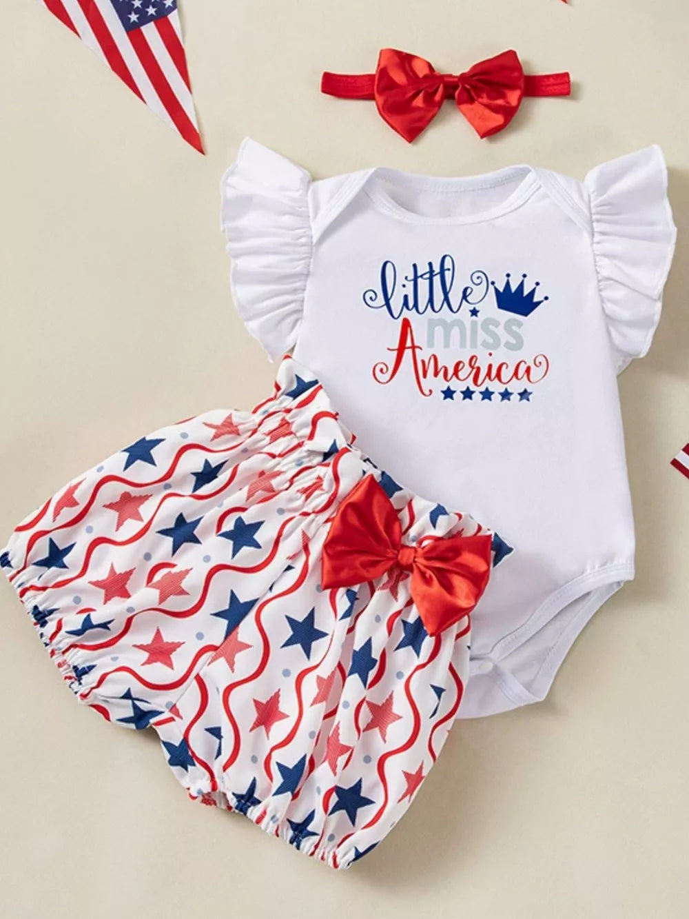 Baby girl's patriotic outfit set with ruffled sleeves, "little miss America" graphic, and star print bloomers with bow.