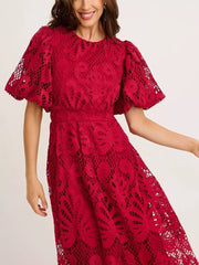 Wine red lace midi dress with puff sleeves and intricate cutout pattern.