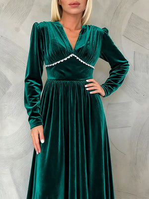 Green velvet ruched V-neck maxi dress with long sleeves and scalloped trim.