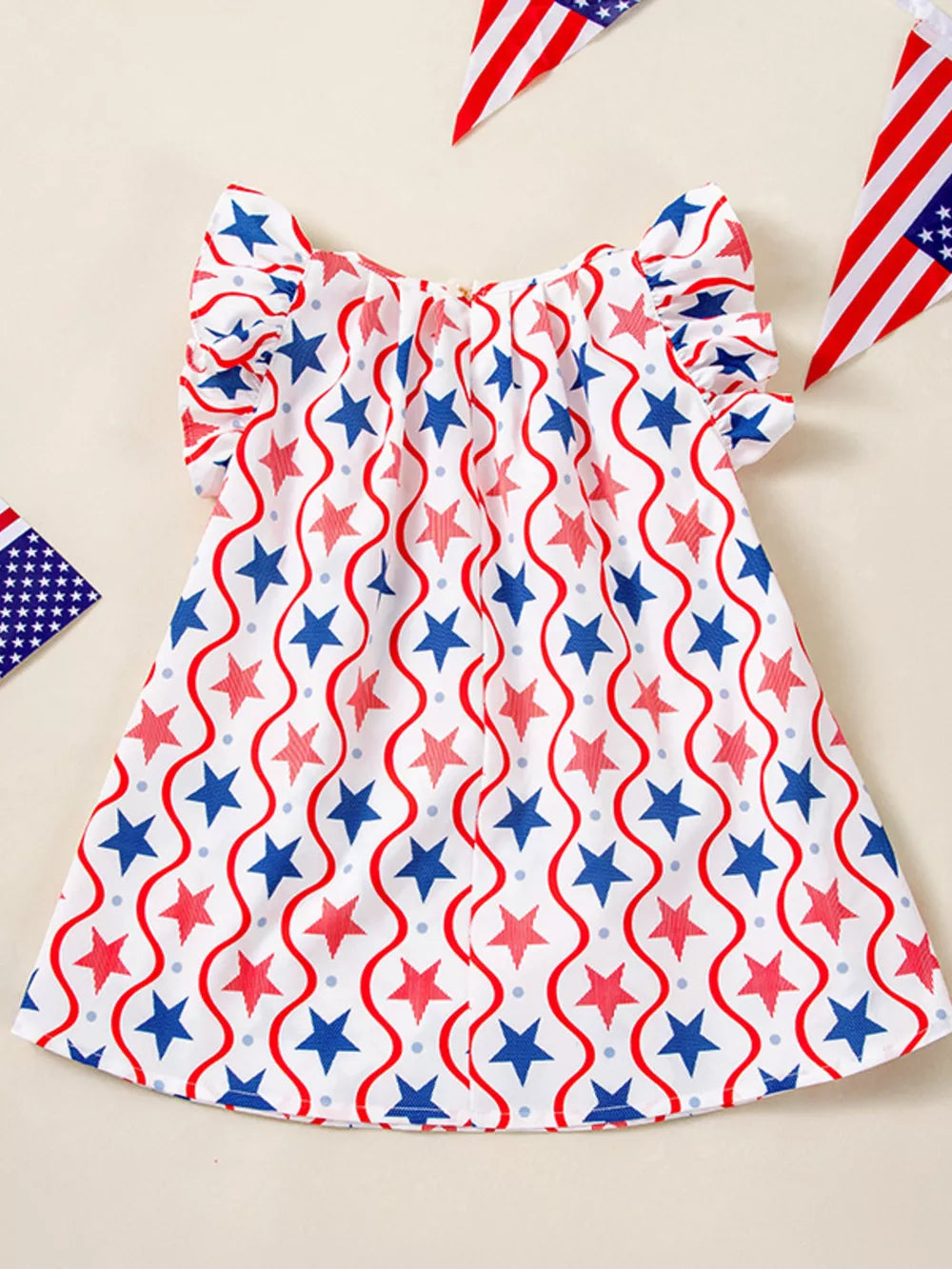 Toddler star print dress with ruffle sleeves and wavy stripe pattern in red, white, and blue cotton.