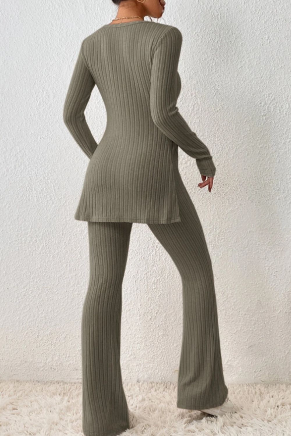 Olive brown ribbed knit co-ord set with long sleeves, side slit top and flared pants.