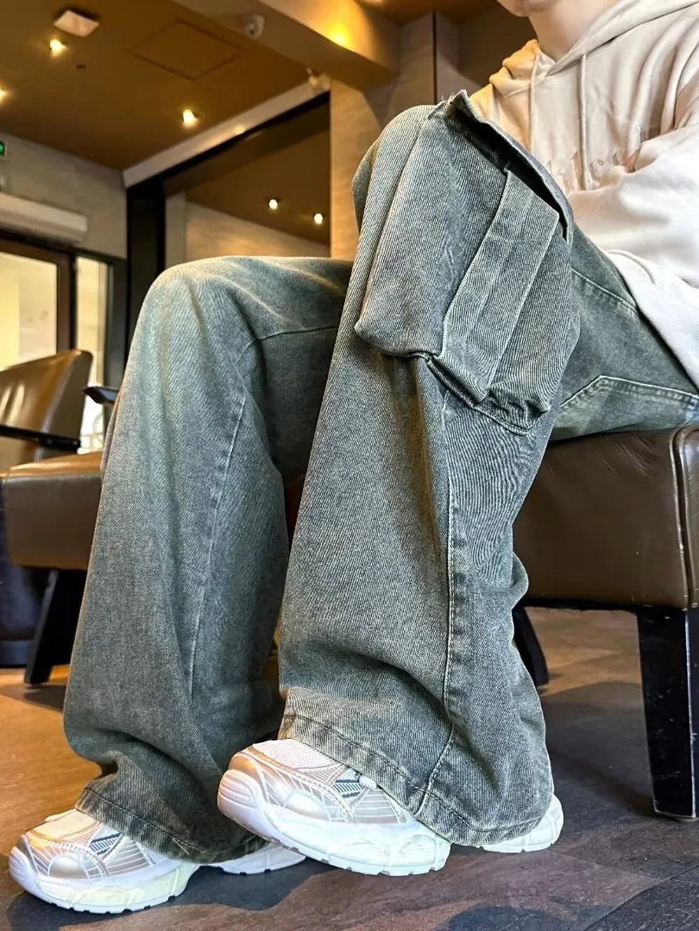 Men's vintage-inspired washed green denim cargo pants with large side pockets.