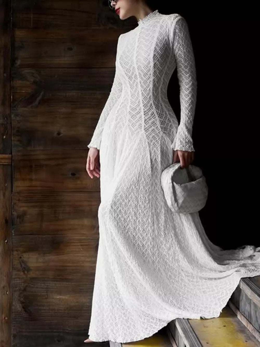 Elegant white lace maxi dress with mock neck and long sleeves, featuring a textured pattern.