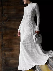 Elegant white lace maxi dress with mock neck and long sleeves, featuring a textured pattern.