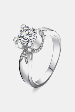 Sterling silver ring with a large solitaire diamond and a halo of smaller diamonds.